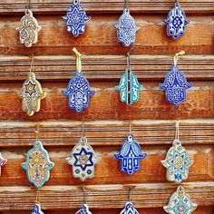 an assortment of handmade ceramic ornaments hanging on a wooden door in the old city