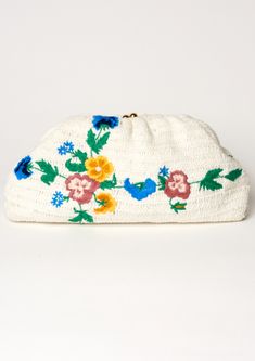 Add some floral flair to your summer wardrobe with the Vela Crochet Clutch. Perfect for beach days or nights out, this clutch features delicate embroidery and crochet details for a playful touch. Its optional gold chain allows for versatile styling options and the cotton stripe lining adds a pop of color. Don't miss out on this fun and functional accessory! Spring Chic Crochet Clutch Bag, Chic Spring Crochet Clutch Bag, Spring Woven Pouch Clutch, Summer White Pouch Clutch, White Pouch Clutch For Summer, Beige Woven Clutch For Spring, Spring Beige Woven Clutch, Beige Bohemian Clutch For Spring, Chic Cream Clutch For Spring