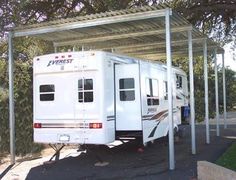 an rv is parked under a covered area