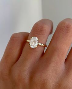 a woman's hand with a diamond ring on it