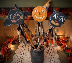 three halloween decorations in a jar on a doily