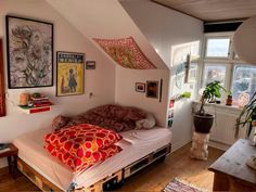 a bed sitting in the middle of a bedroom next to a window