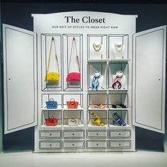 the closet is full of purses and handbags on display in front of an advertisement