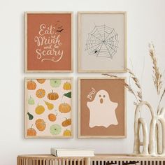 there are four halloween prints on the wall