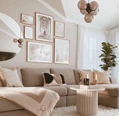 a living room filled with lots of furniture and pictures on the wall above it's coffee table