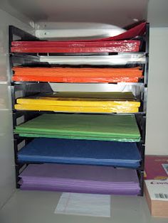 the shelves are filled with different colored sheets