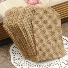 small burlap bags are sitting on a doily