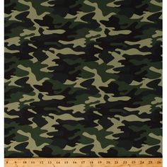 camouflage print fabric in green and black, with a ruler on the bottom right side