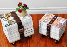 two suitcases are stacked on top of each other, with flowers in the vase