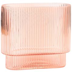 a pink glass vase sitting on top of a white table