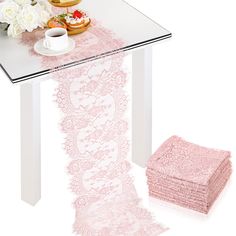 pink lace table runner and matching napkins on top of a white table with flowers