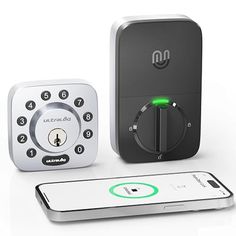 the smart lock is next to an iphone and another device with its keypad on it