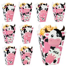 pink and black cow cupcakes with popcorn in them