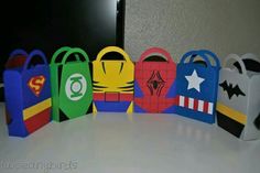 paper bags are lined up in the shape of superheros