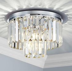 a crystal chandelier hanging from the ceiling in a room with white walls and ceilings