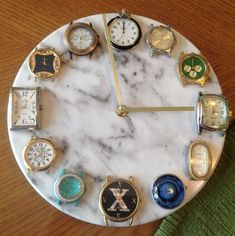 a marble clock with many different watches on it