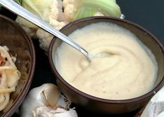 two bowls filled with soup and some vegetables