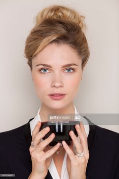 a woman taking a photo with her cell phone stock - fotografie