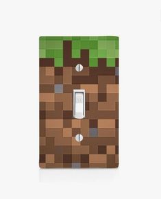 a light switch cover with an image of a brown and green minecraft block on it