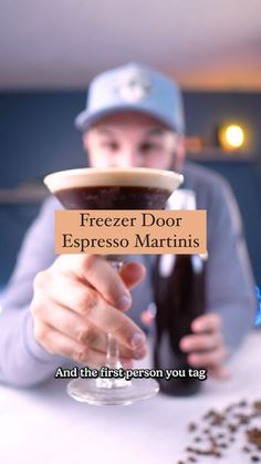 a person sitting at a table with a drink in their hand and the caption freezer door espresso martinis