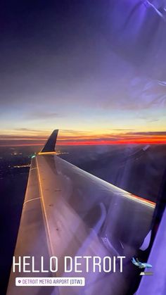 an airplane wing with the words hello detroit in front of it at sunset or dawn