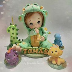 there is a small figurine that looks like a baby in a frog costume