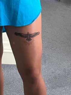 a woman's leg with a tattoo on the side of her body and a small bird