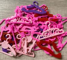 a pile of pink and purple plastic hair clips