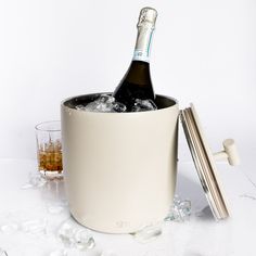 an ice bucket with a bottle of champagne in it