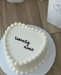 a white cake with the words twenty nine written on it