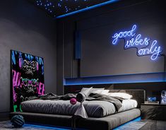 a large bed sitting under a neon sign in a bedroom