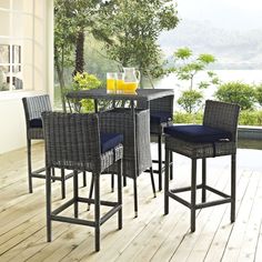 an outdoor table and chairs with drinks on it