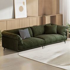 a green couch sitting on top of a white rug in a living room next to a window