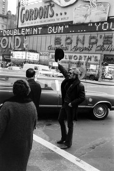 an old black and white photo of people on the street