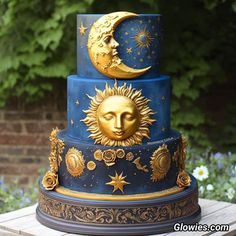 a three tiered cake with sun and moon decorations