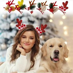 a woman sitting next to a dog with reindeer antlers on their head and christmas decorations behind her