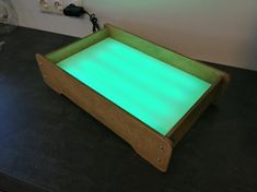 a wooden tray with green light on it