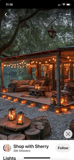 an image of a small cabin with lights on the porch and patio area in front