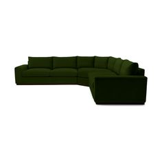 a large green couch sitting on top of a white floor