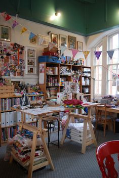 a room filled with lots of books and desks