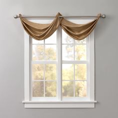 an open window with curtains hanging over it