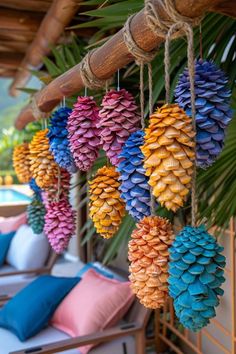 colorful pine cones hanging from the ceiling next to a pool