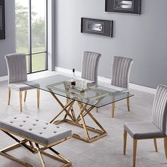 a glass table with four chairs and a bench