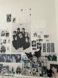 the wall is covered with many pictures and magnets