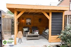 an outdoor living area with two chairs and a couch