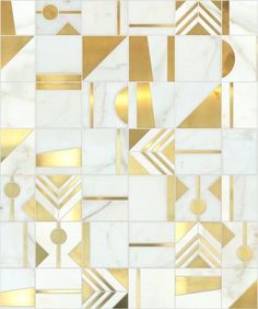 a white and gold tiled wall with geometric shapes