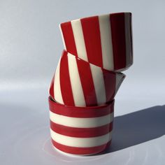 two red and white striped cups stacked on top of each other