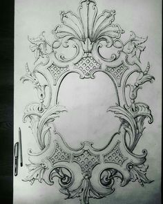 a drawing of an ornate frame with scrolls and flowers on it, as well as a pen