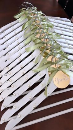 a bunch of white wooden clothes pins sitting on top of a table