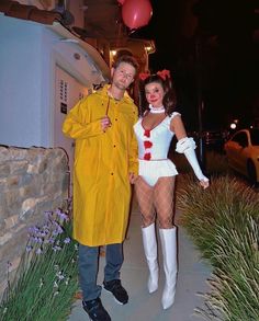 a man and woman dressed in costumes standing next to each other